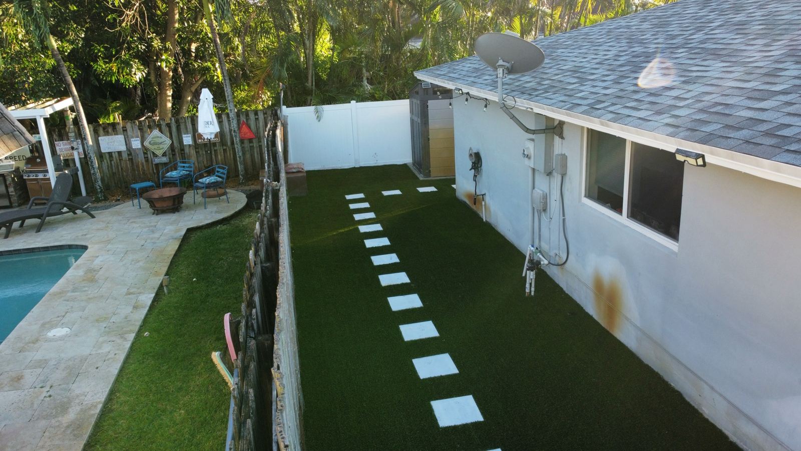 Turf side yard with concrete stepping pads by Concrete Solutions Today, serving Davie, FL