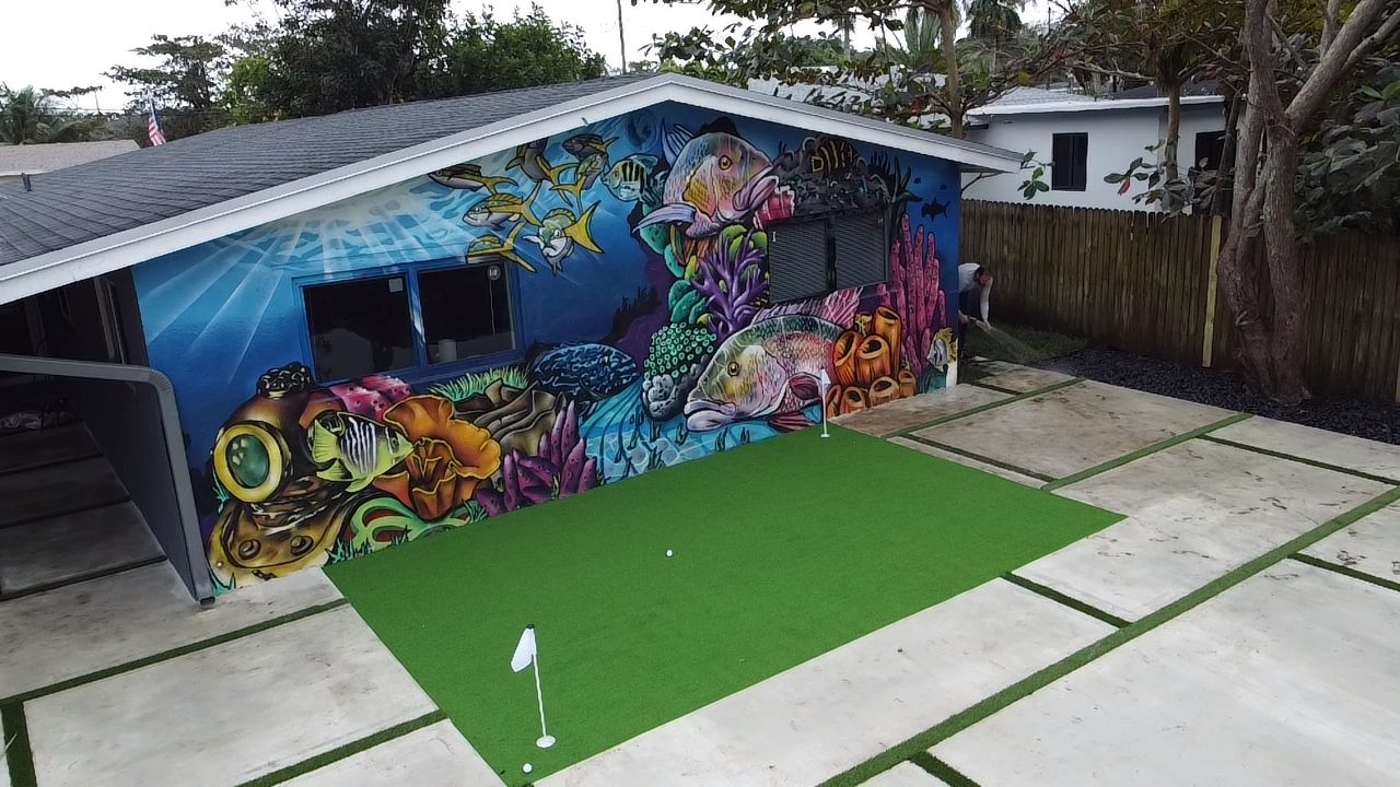 Backyard artificial turf putting green with concrete and turf joints, installed by Concrete Solutions Today in Broward County, Florida