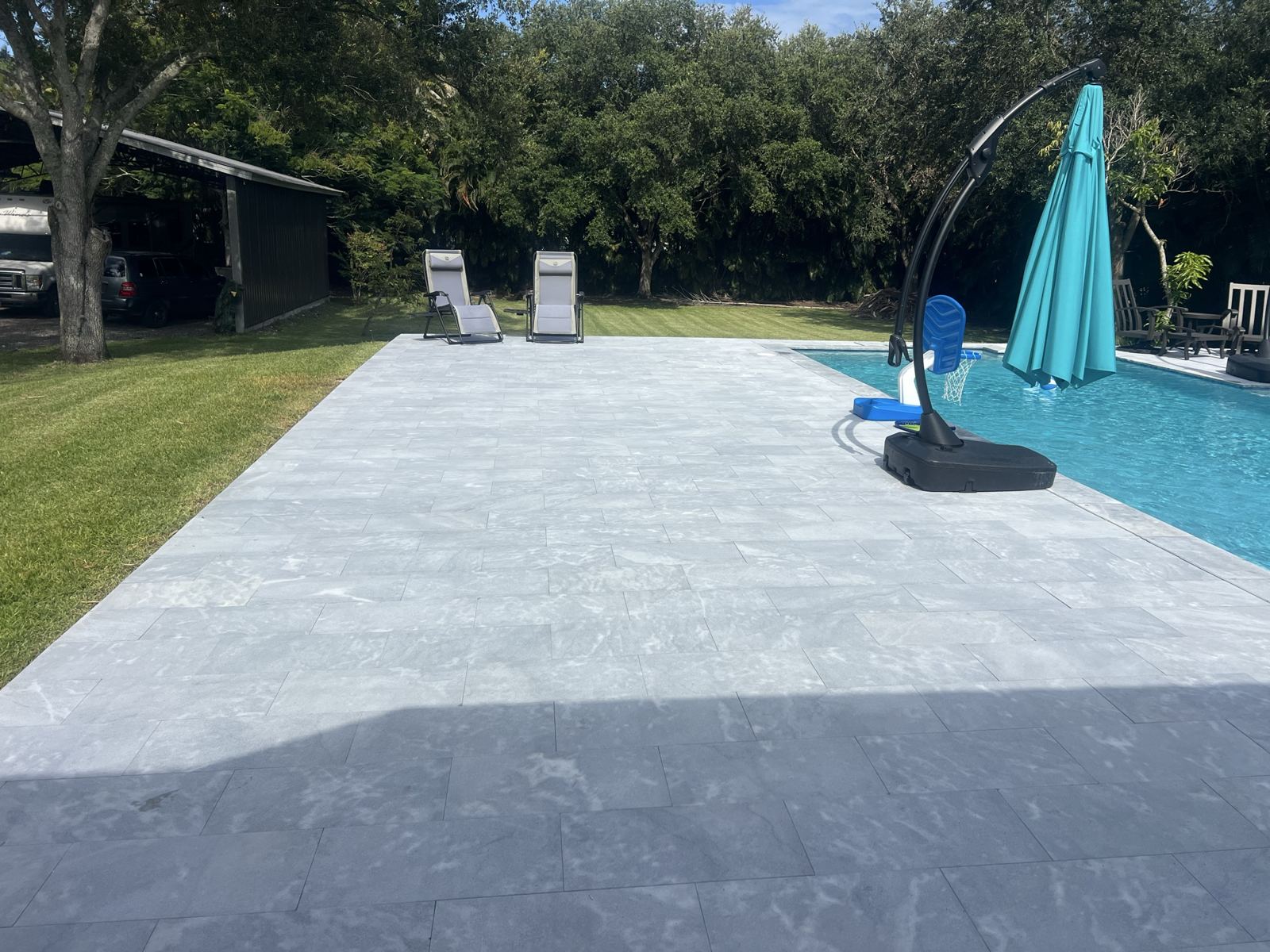 Large-format pool deck with a clean, modern finish, Broward County, Florida
