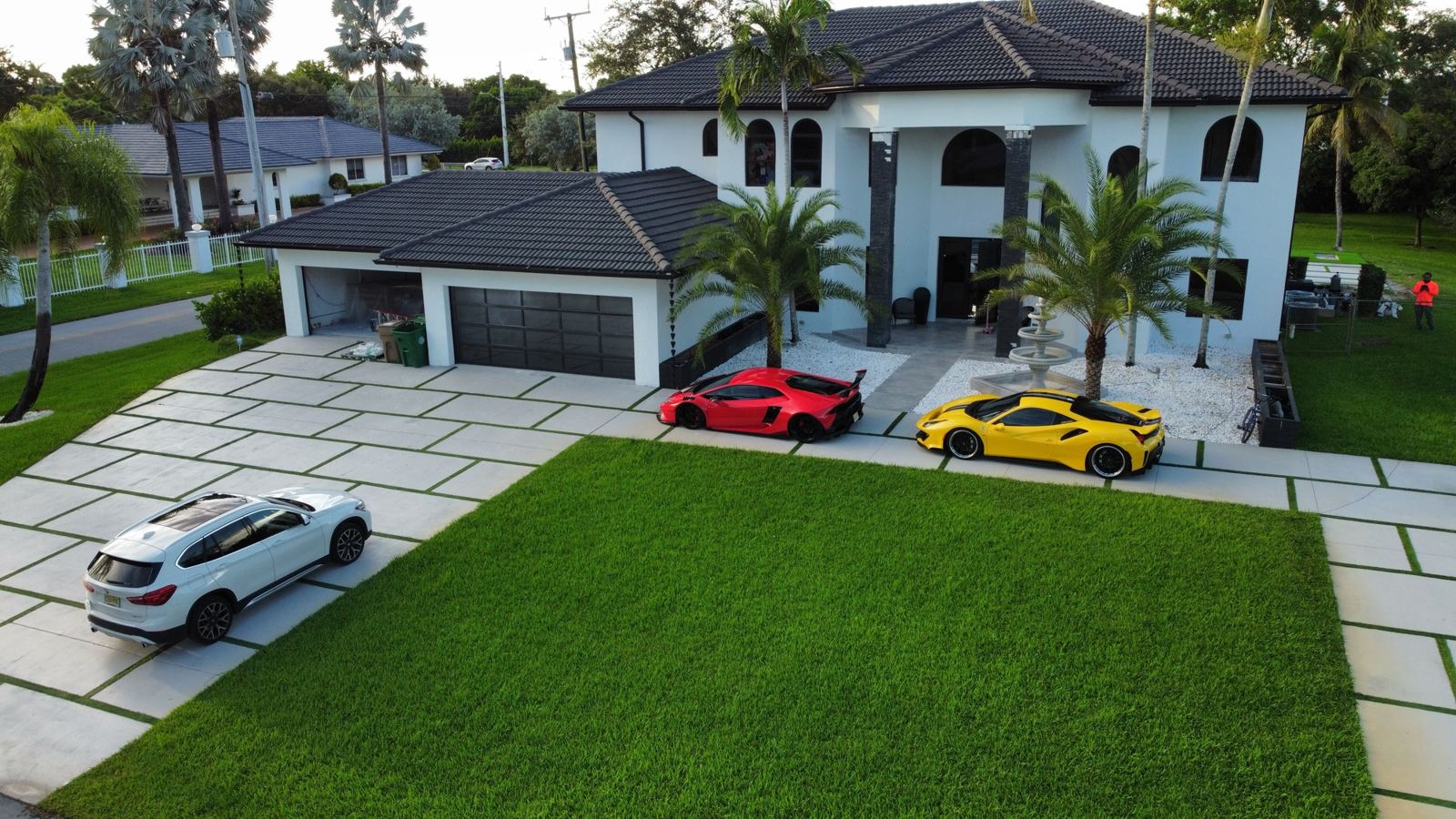 Artificial turf lawn and concrete driveway by Concrete Solutions Today, serving Lauderdale-by-the-Sea, FL