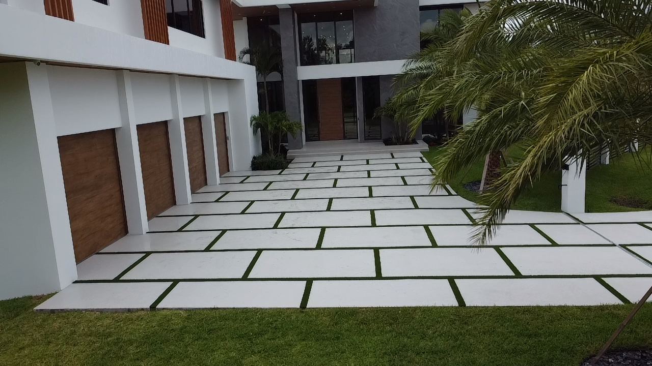 Modern concrete slab driveway with grass joints by Concrete Solutions Today, serving Davie, FL