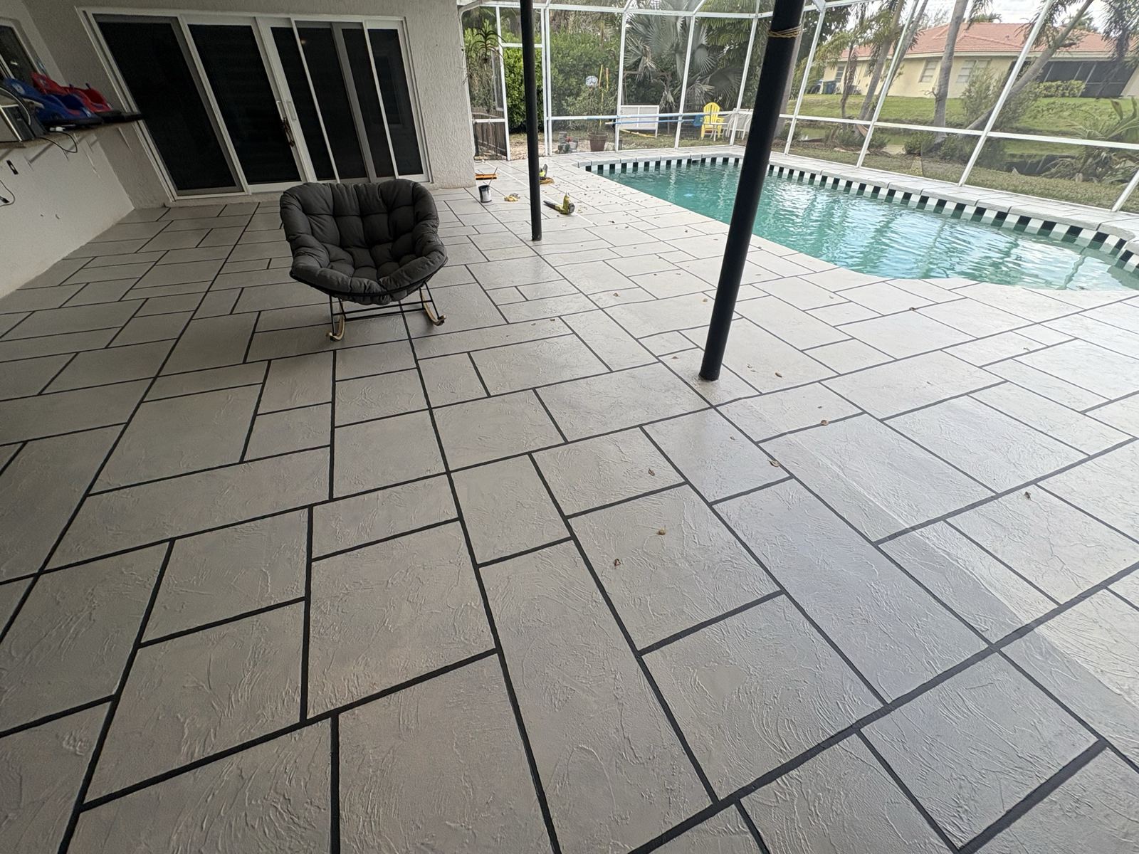 Resurfaced pool deck inside a screen enclosure by Concrete Solutions Today, serving Fort Lauderdale, FL